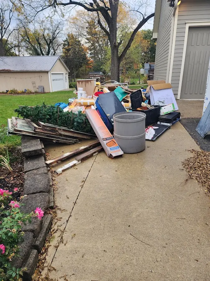 Dumpster being loaded with debris for 12 Yard Dumpster Rental in Adel